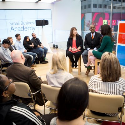 People are interviewed on a stage