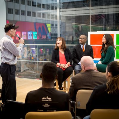 People are interviewed on a stage