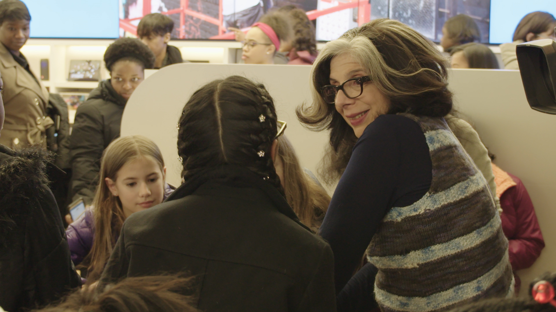 Photo of woman talking to two girls