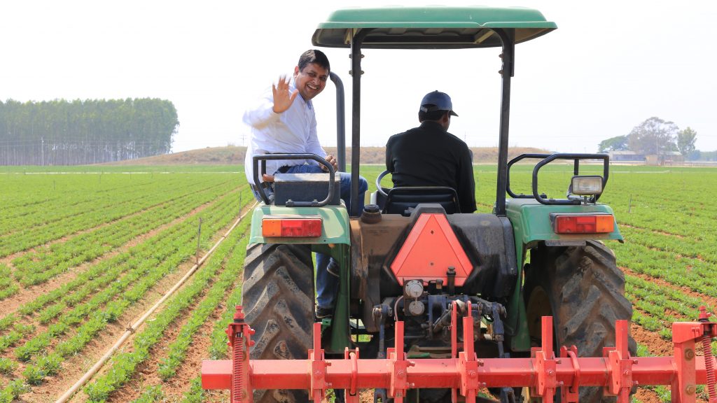 Prashant Gupta of Microsoft riding on the back of a tractor in India