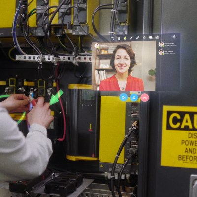 a woman working with her hands conferences with another woman via HoloLens technolgoy