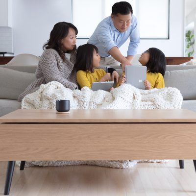 A family uses Surface Pro Go in a living room