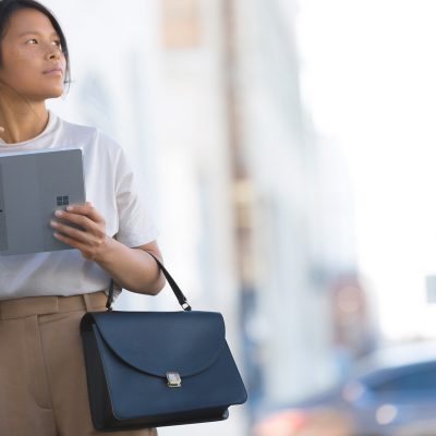 A woman holds a Surface Go