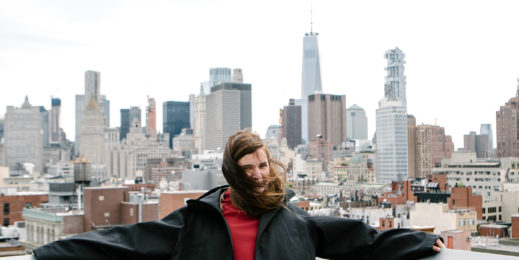 woman stands on roof of hotel