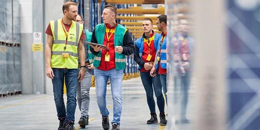 Team of workers walking through a warehouse