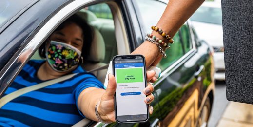 Woman shows her phone while in a car