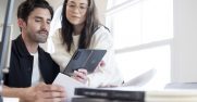 Man and woman viewing what's on a Surface Duo 2