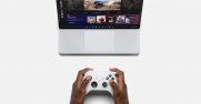 A person playing a game on a Surface laptop using a Xbox controller