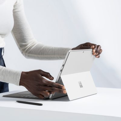 A person opening a Surface Pro 8