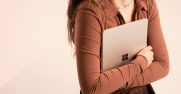 Woman holding Surface Laptop Go 2 in Sandstone