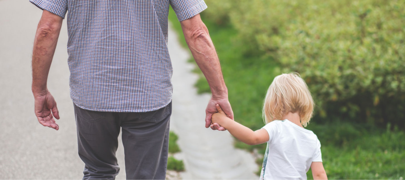 Man and child walking hand in hand