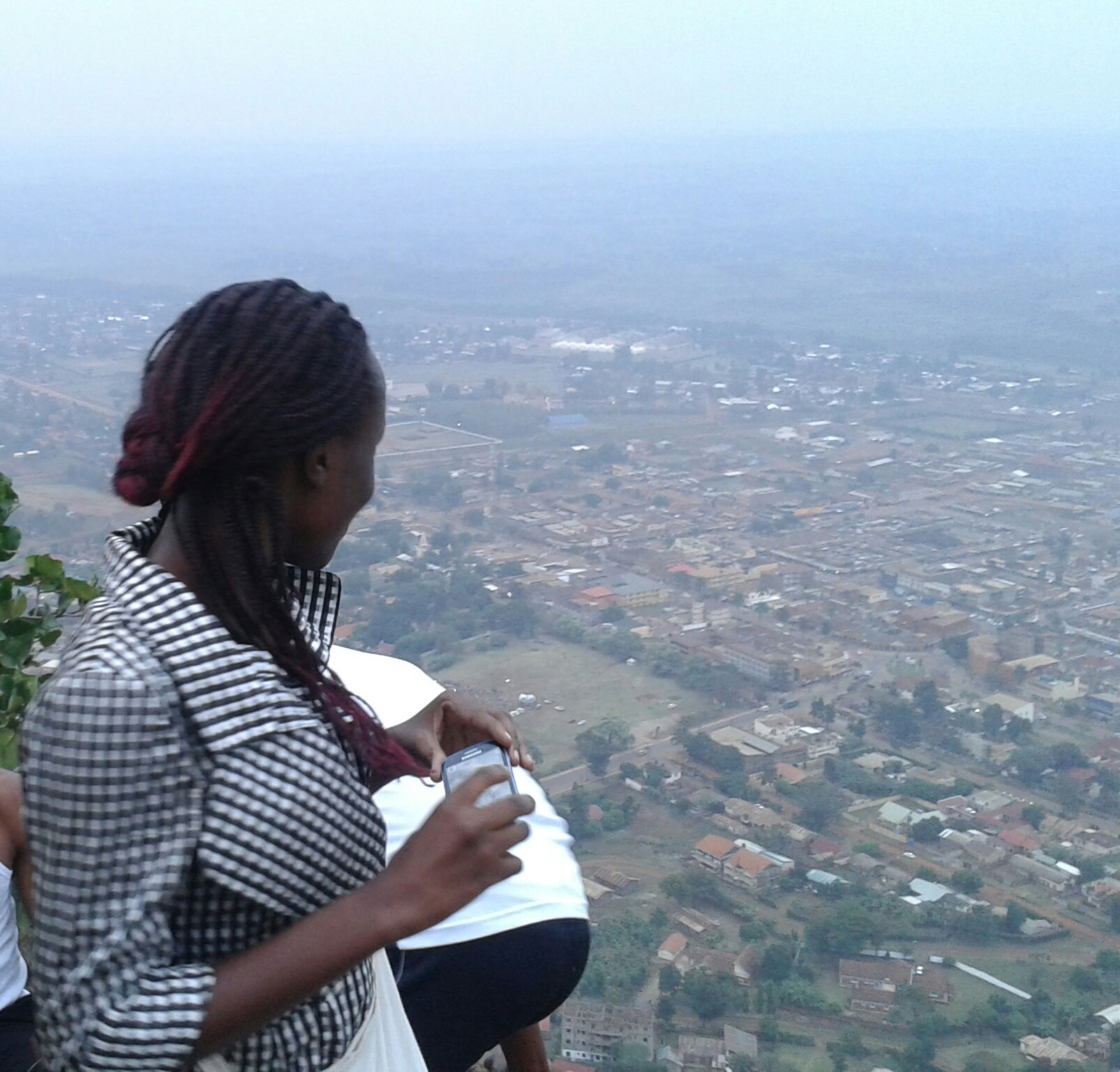 Woman looking down on city from elevated position