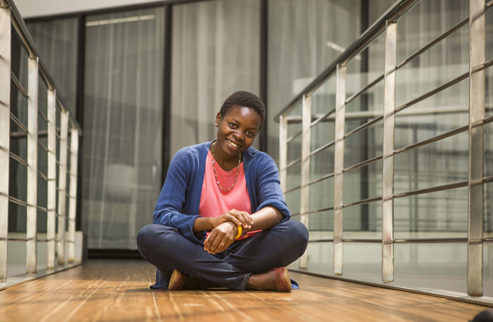 Female engineer sitting cross legged 