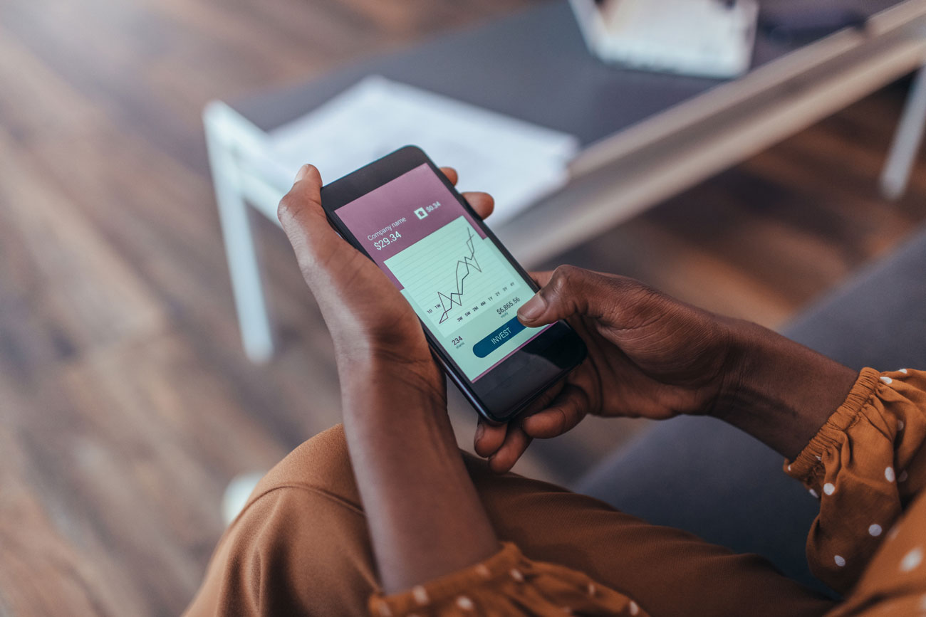 Female seated holding a cellphone with both hands