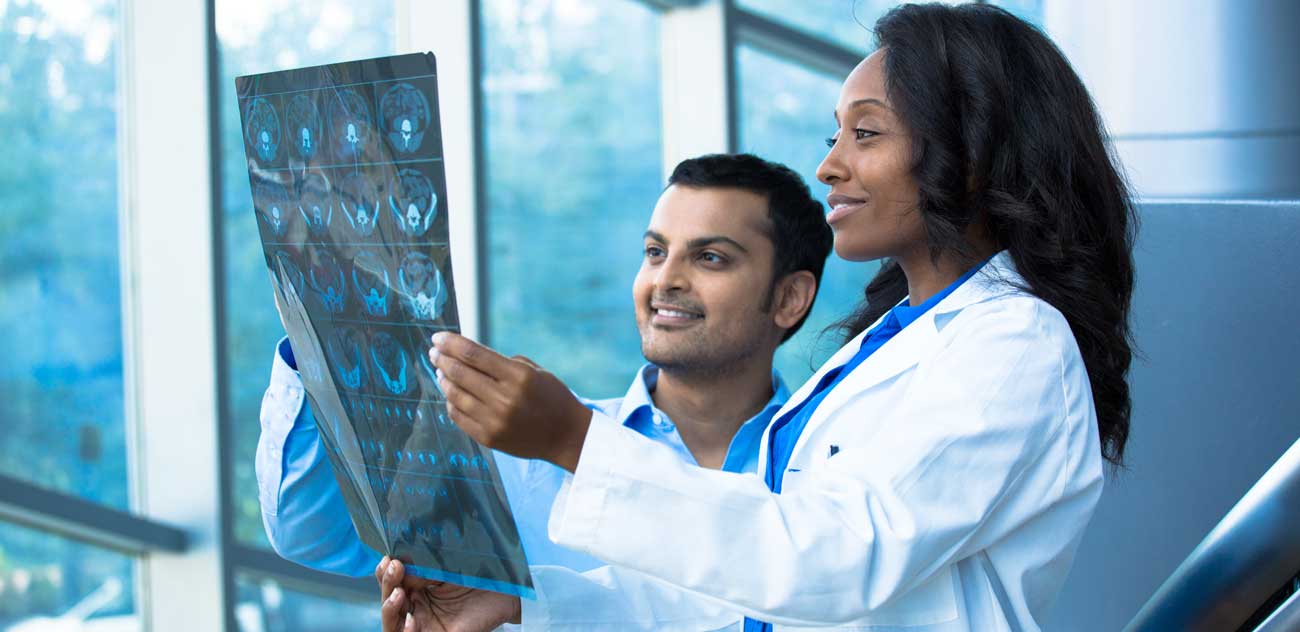 Doctors examining an X-ray report.