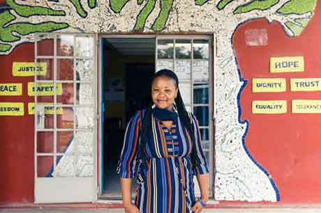 Woman stands in front of class door