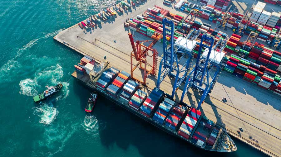 A docked cargo ship stands ready to have stock offloaded