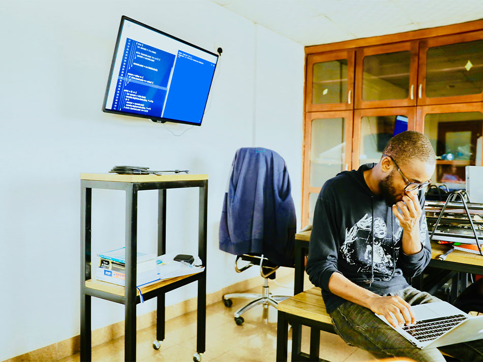 A person sitting at a desk using a computer