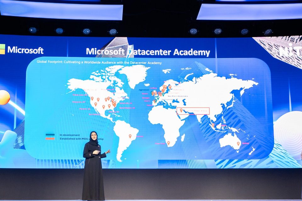 two women on stage presenting