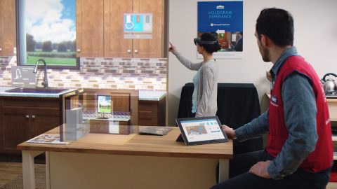 A customer at one of Lowe’s stores with the HoloLens pilot program looks at renovation choices in a test kitchen.