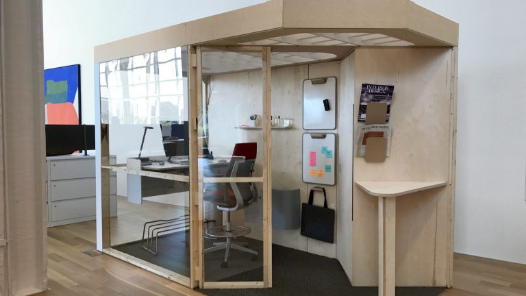 A fourth iteration of the CEO office has windows, a bookshelf and a small white boards.