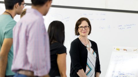 Kathleen Hogan speaks with two people on the Microsoft campus.