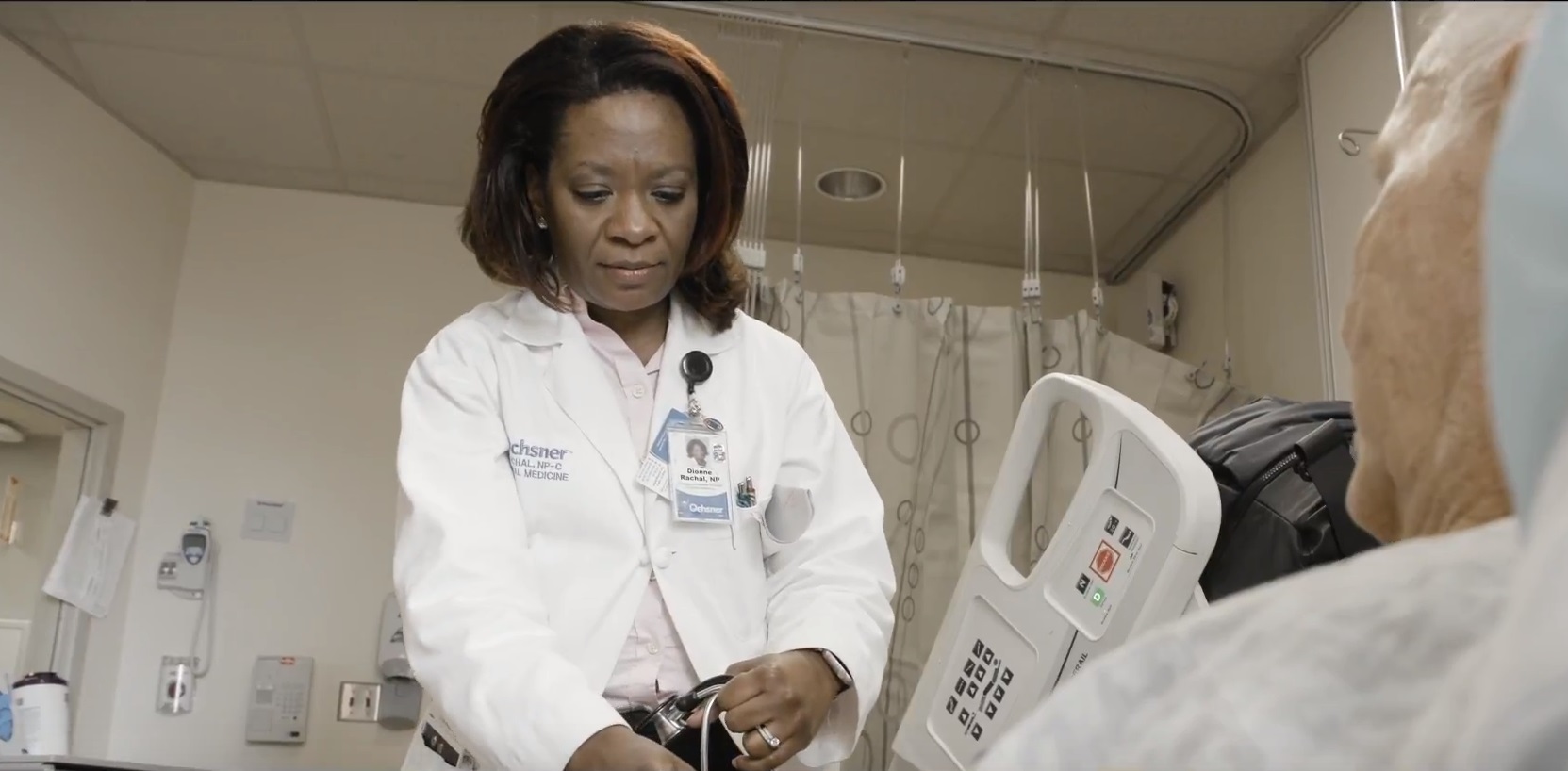 A nurse practitioner checks on a patient at a hospital