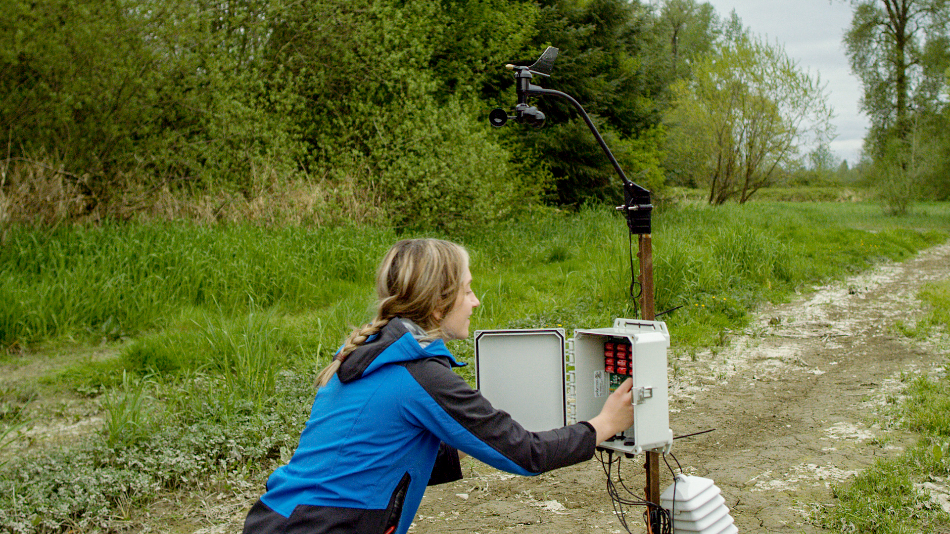 A FarmBeats hardware researcher checks a farm ground sensor