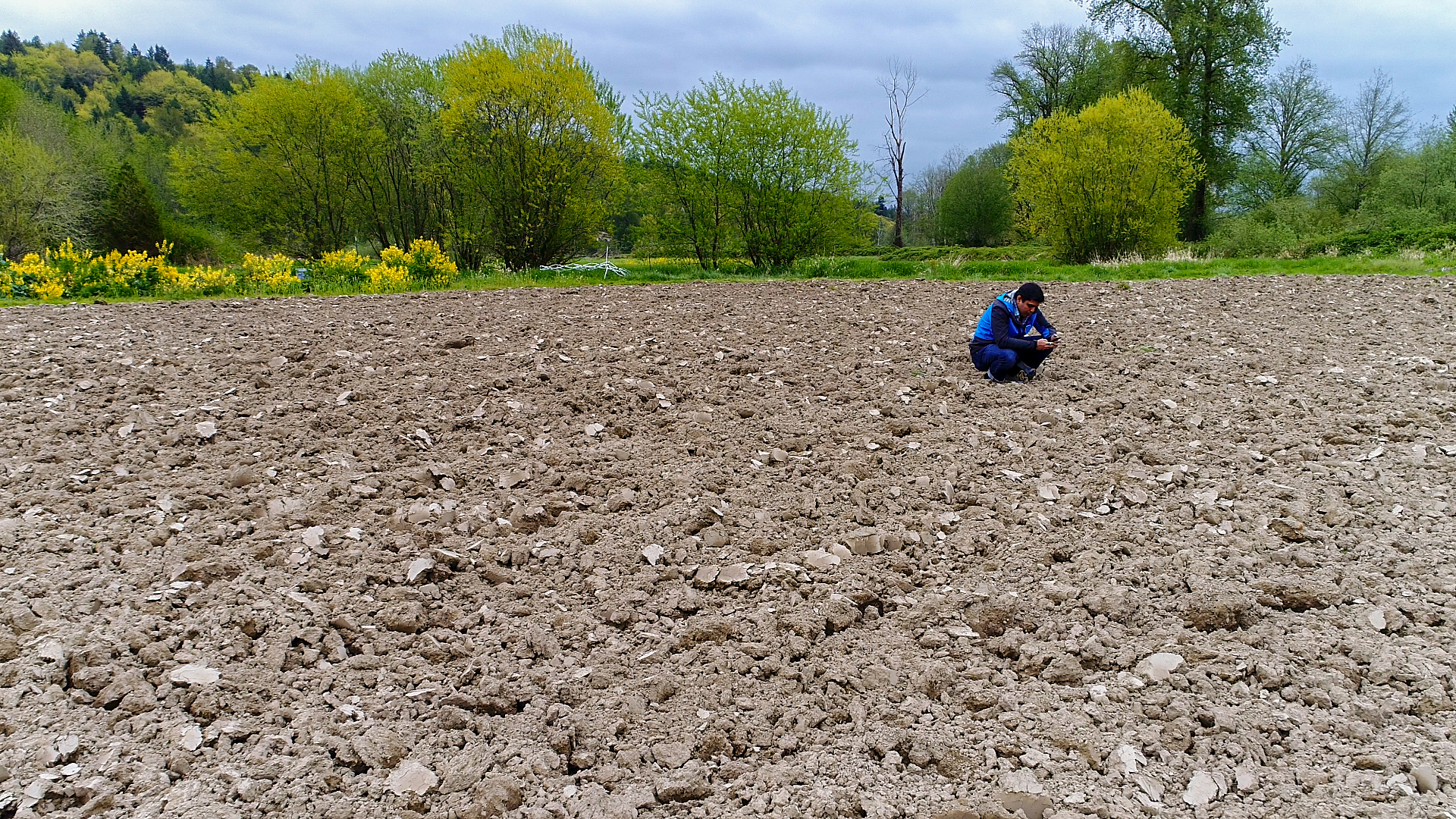 Microsoft prinicpal researcher Ranveer Chandra checks soil at Dancing Crow Farm