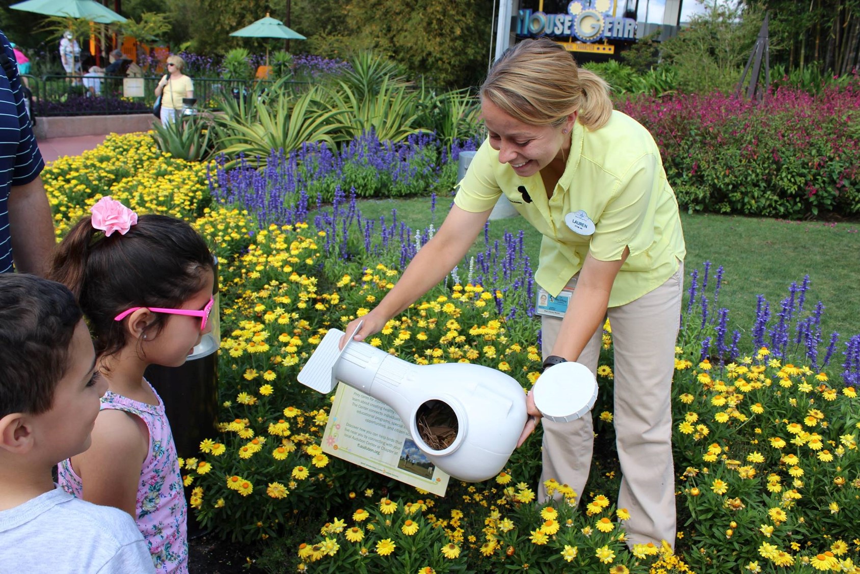 A Disney employee shows a young guest a custom-made birdhouse its scientists created for purple martins. 