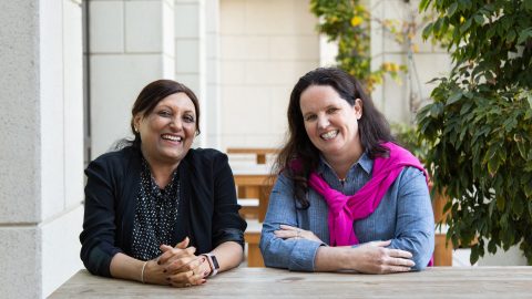 two women sit side by side