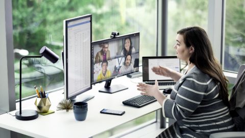 A woman chats with colleagues over Microsoft Teams