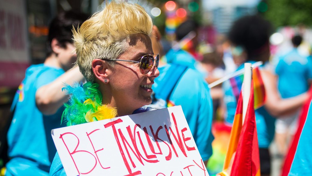 Parade-goer holding a sign