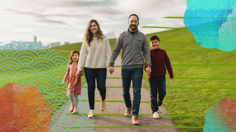 A family - man, woman, and two children - walking in a park