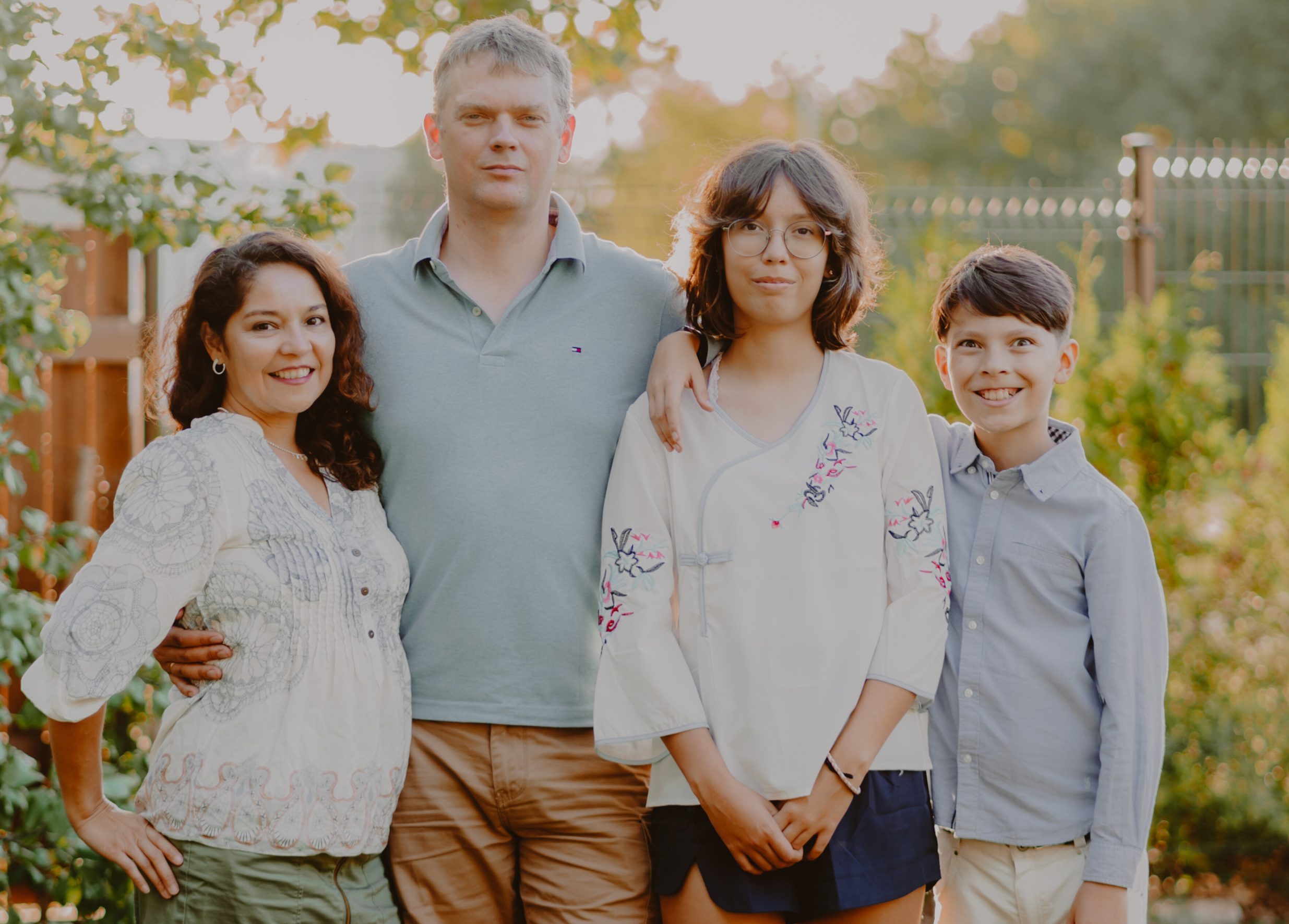 Sandra standing next to her husband and two kids.