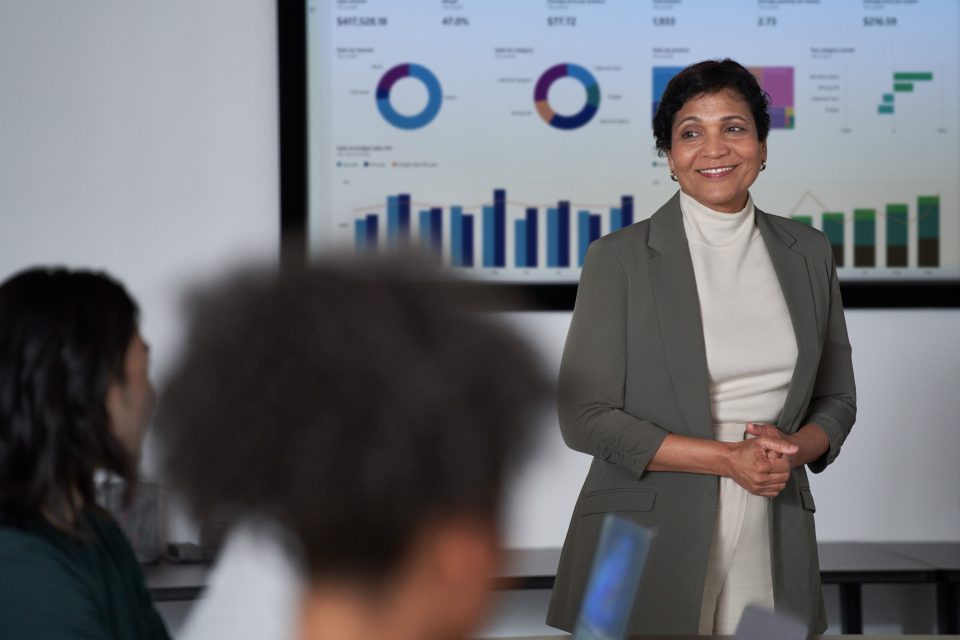 woman speaking in front of a team