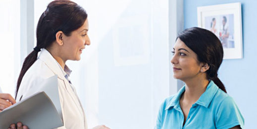 Team of doctors talking to patient