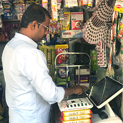 Kirana store owner operates Snapbizz’s PoS terminal