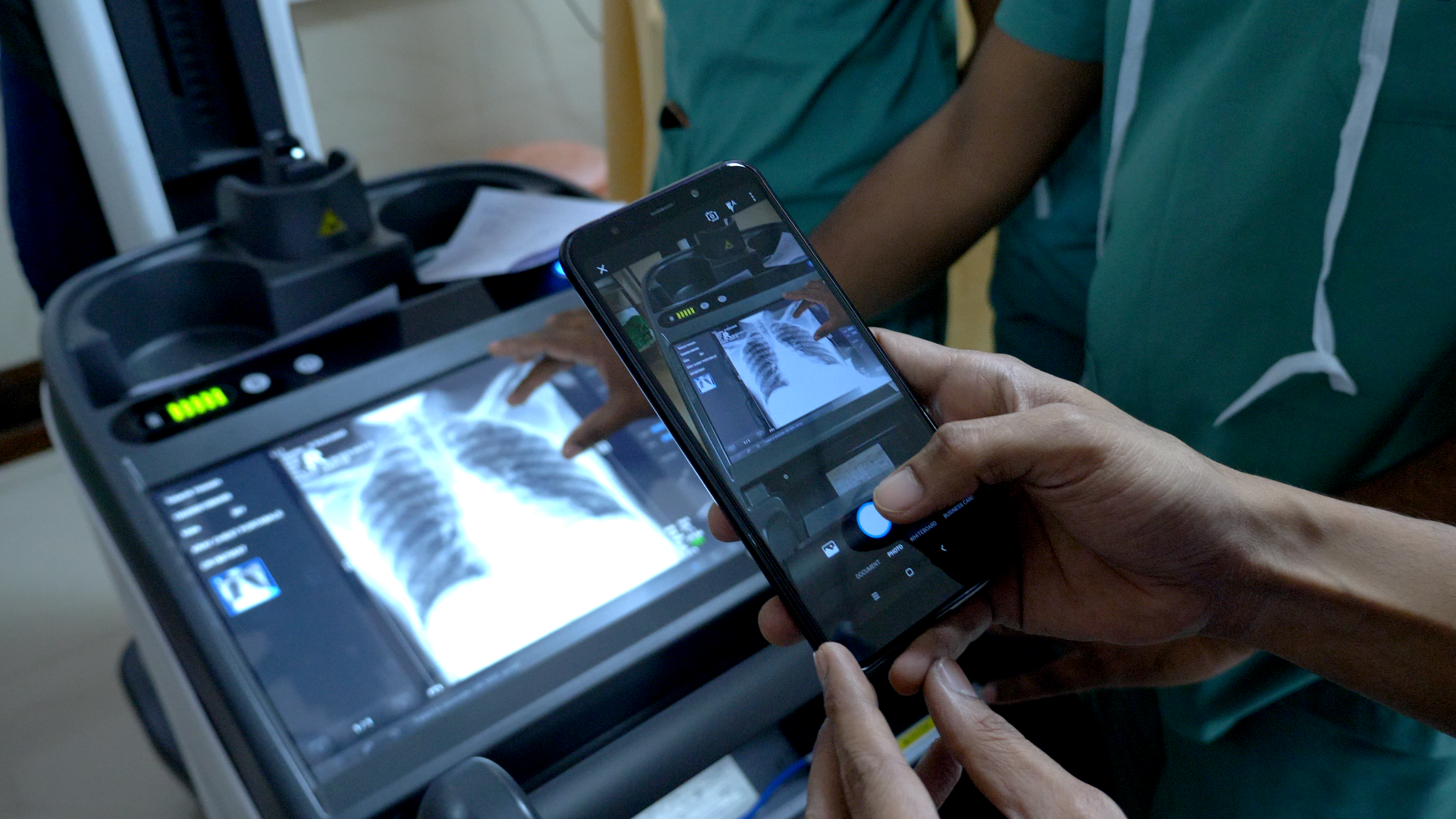 a person taking a photo of an x-ray