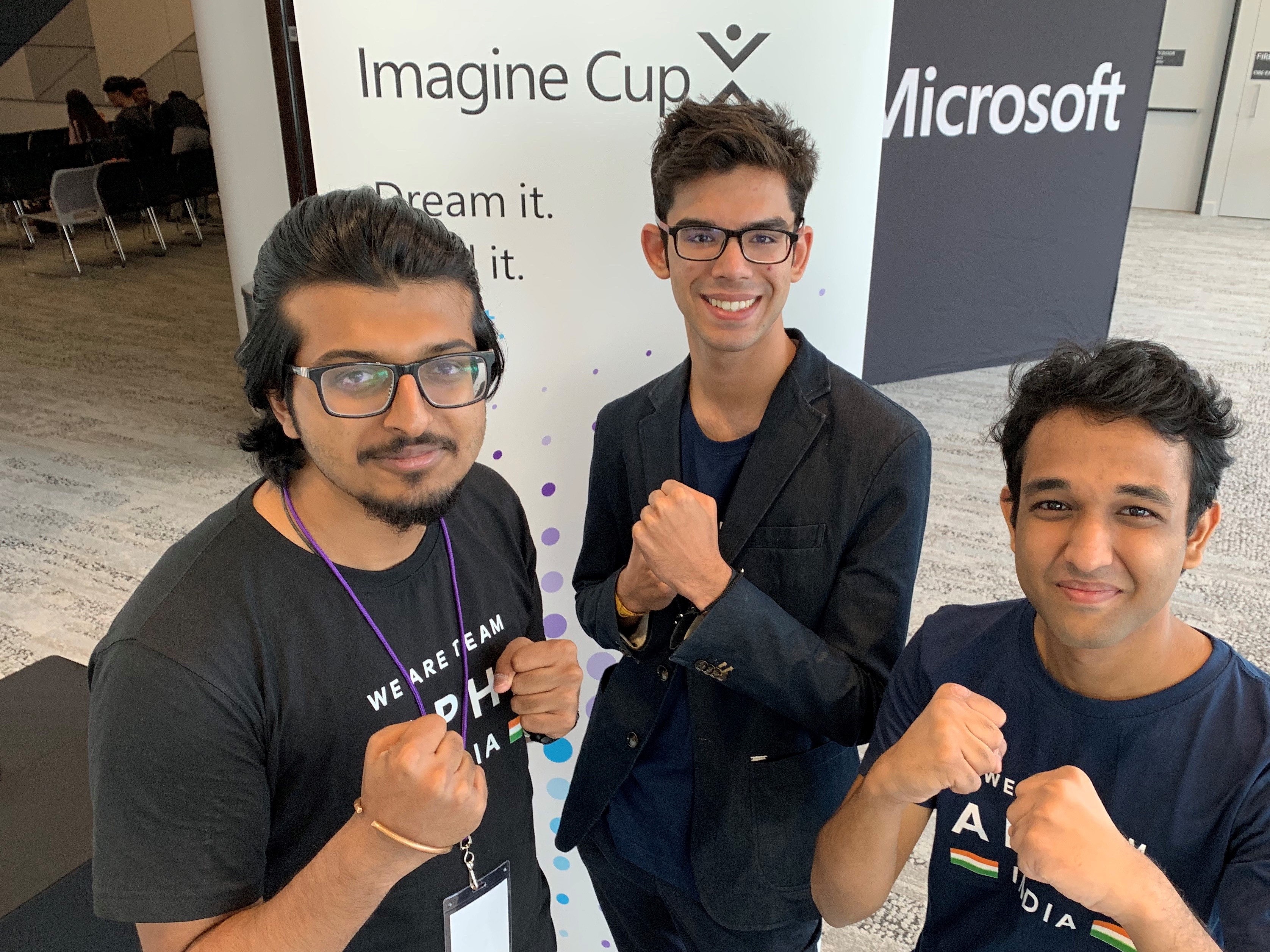 three boys posing for the camera with clenched fists