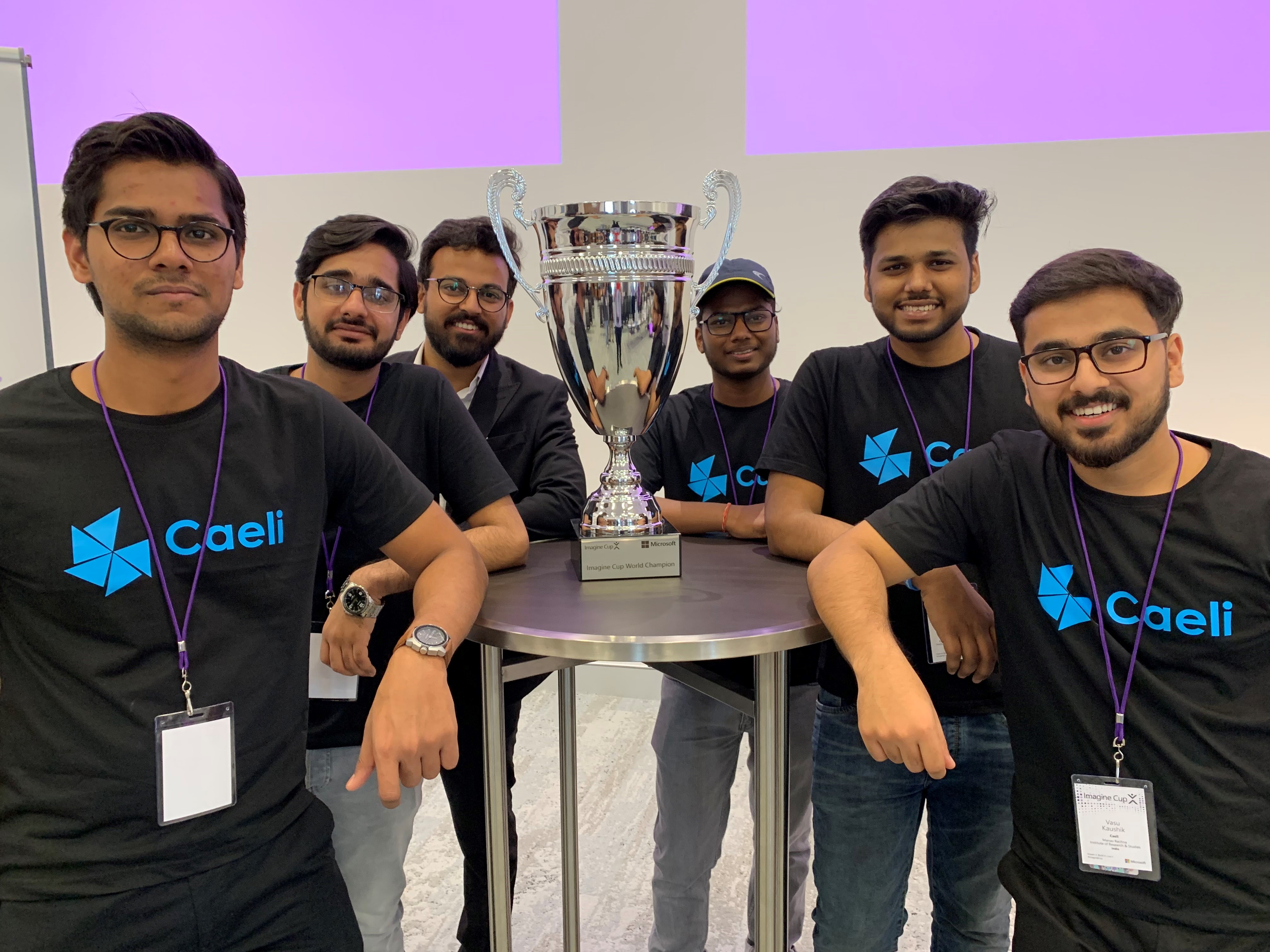 a group of boys pose with a trophy