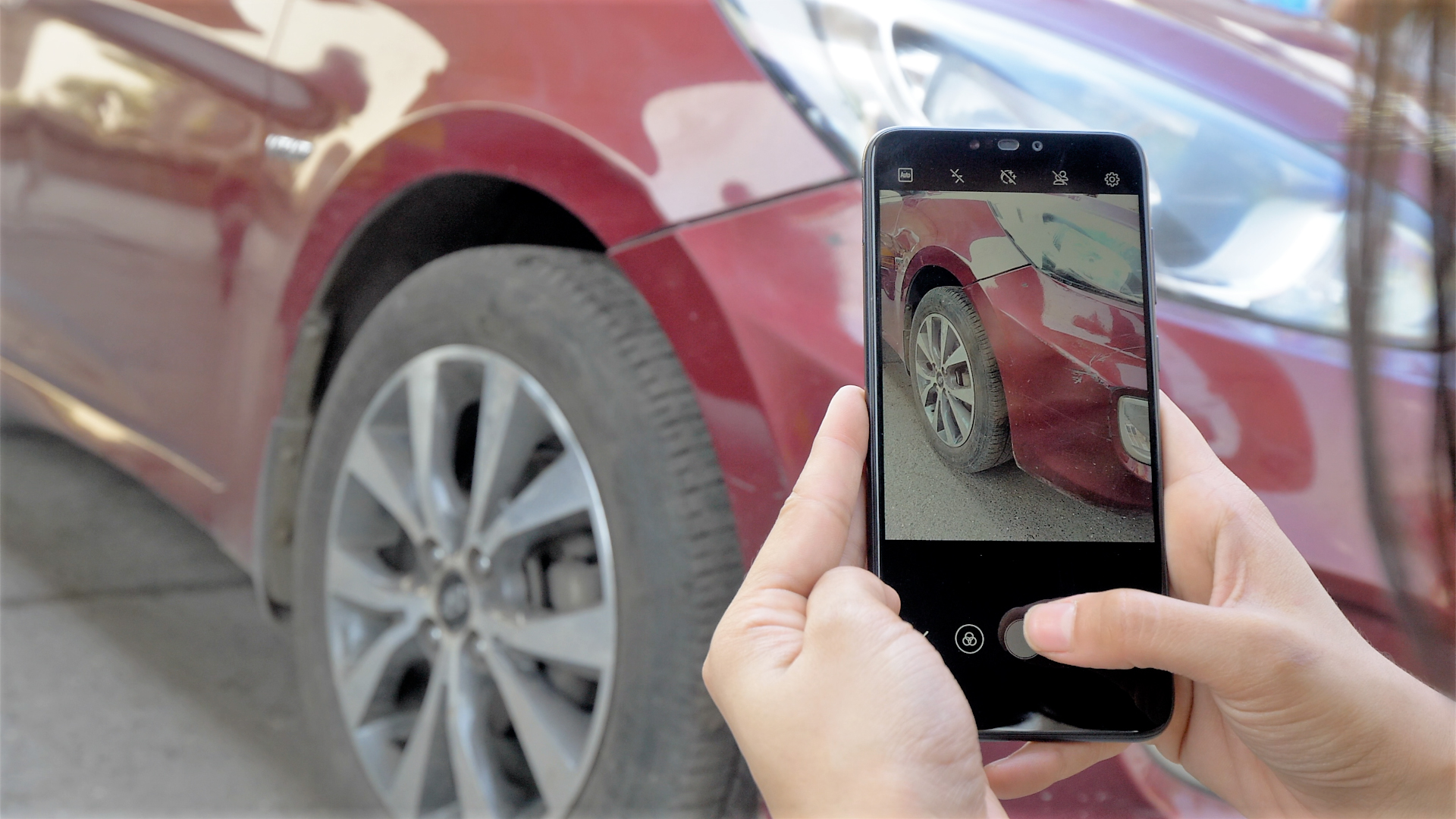 A person clicking snapshot of a car's tyre