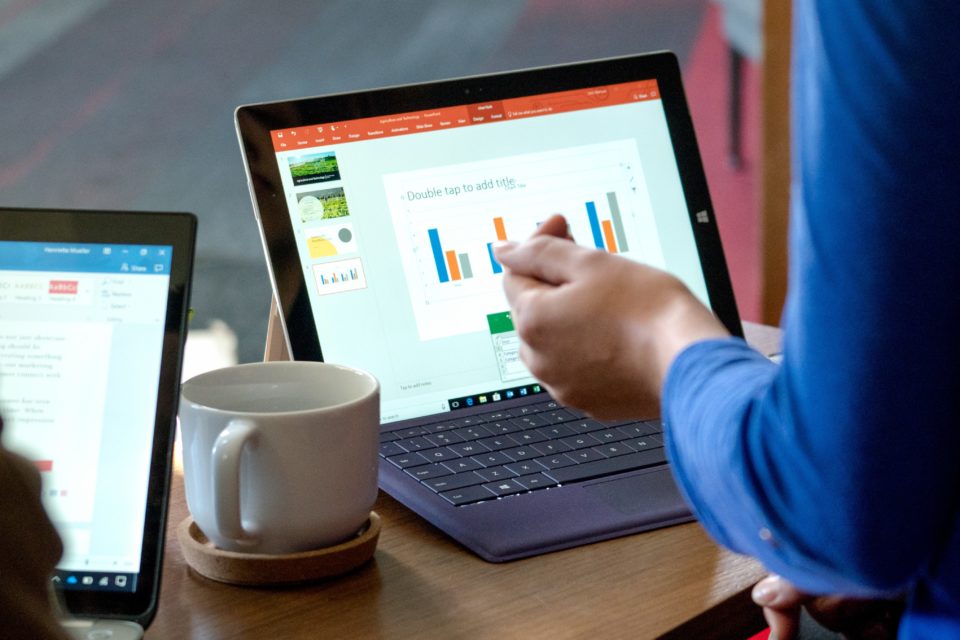 photo of a laptop and a coffee cup on a table