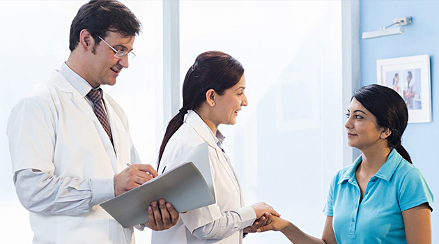 Patient in conversation with two doctors