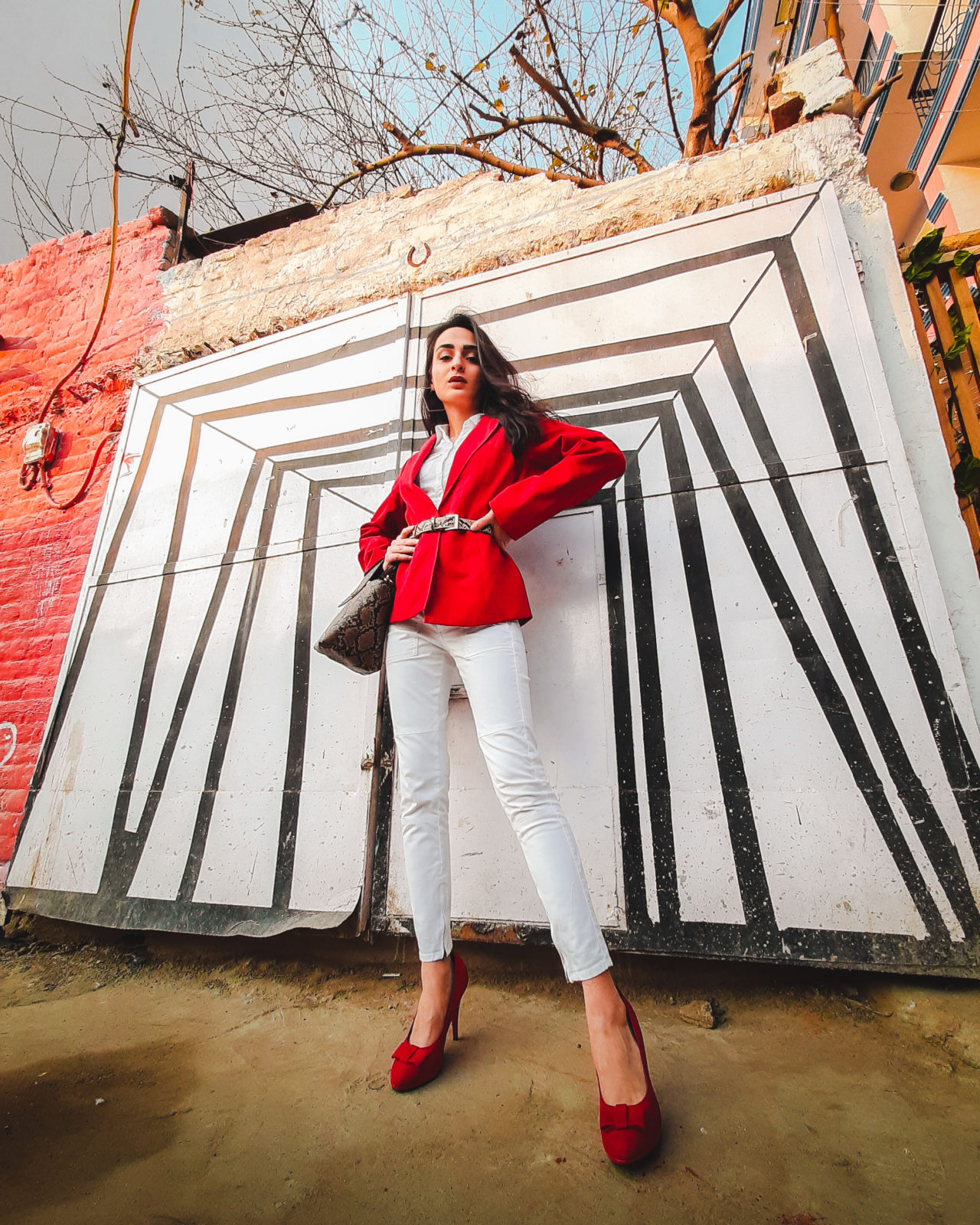 a female model posing in front of a wall