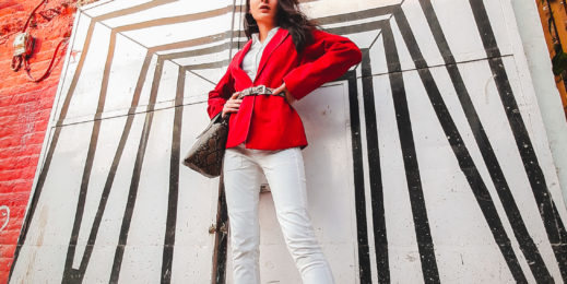 a female model posing in front of a wall