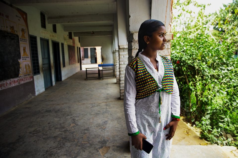 Photo of a girl standing in a corridor.