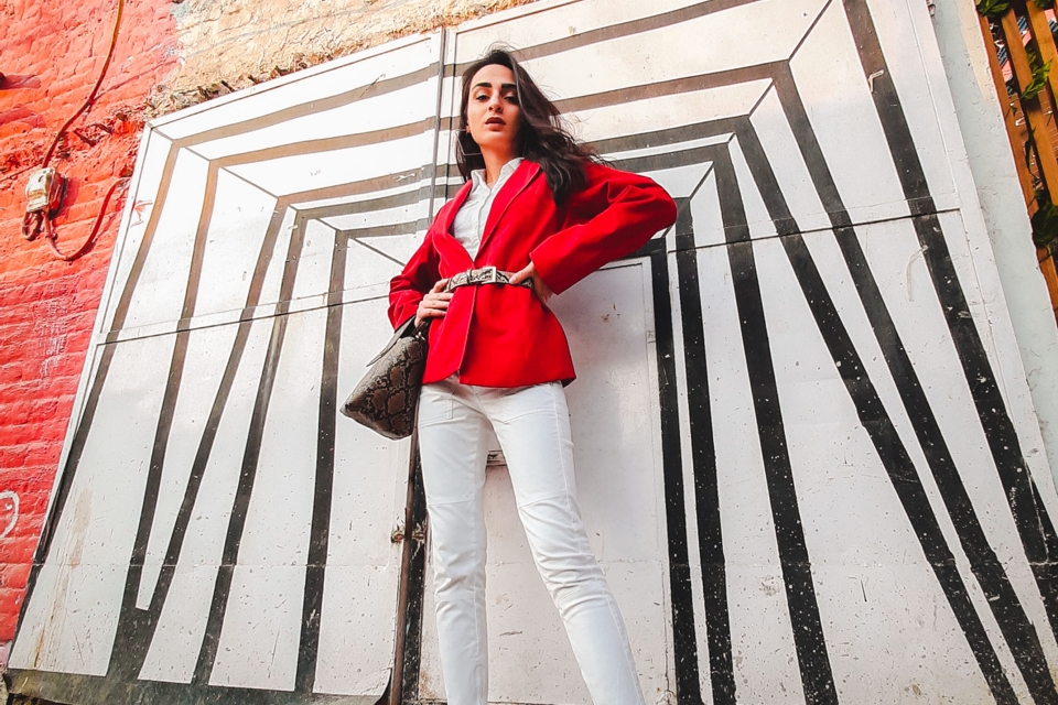 Photo of a fashion model posing in front of a wall mural