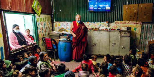 Photo of a man teaching a class of kids in rural India