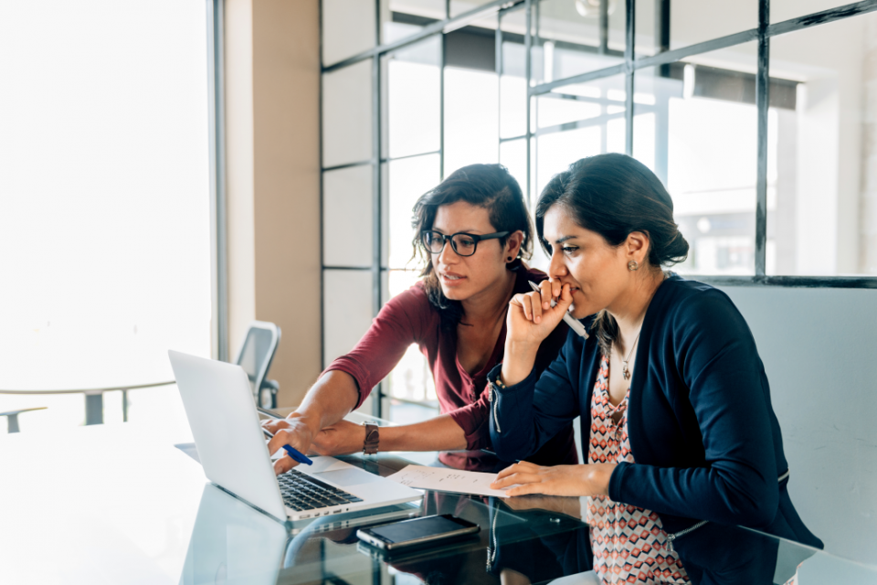 Two women working on a laptop